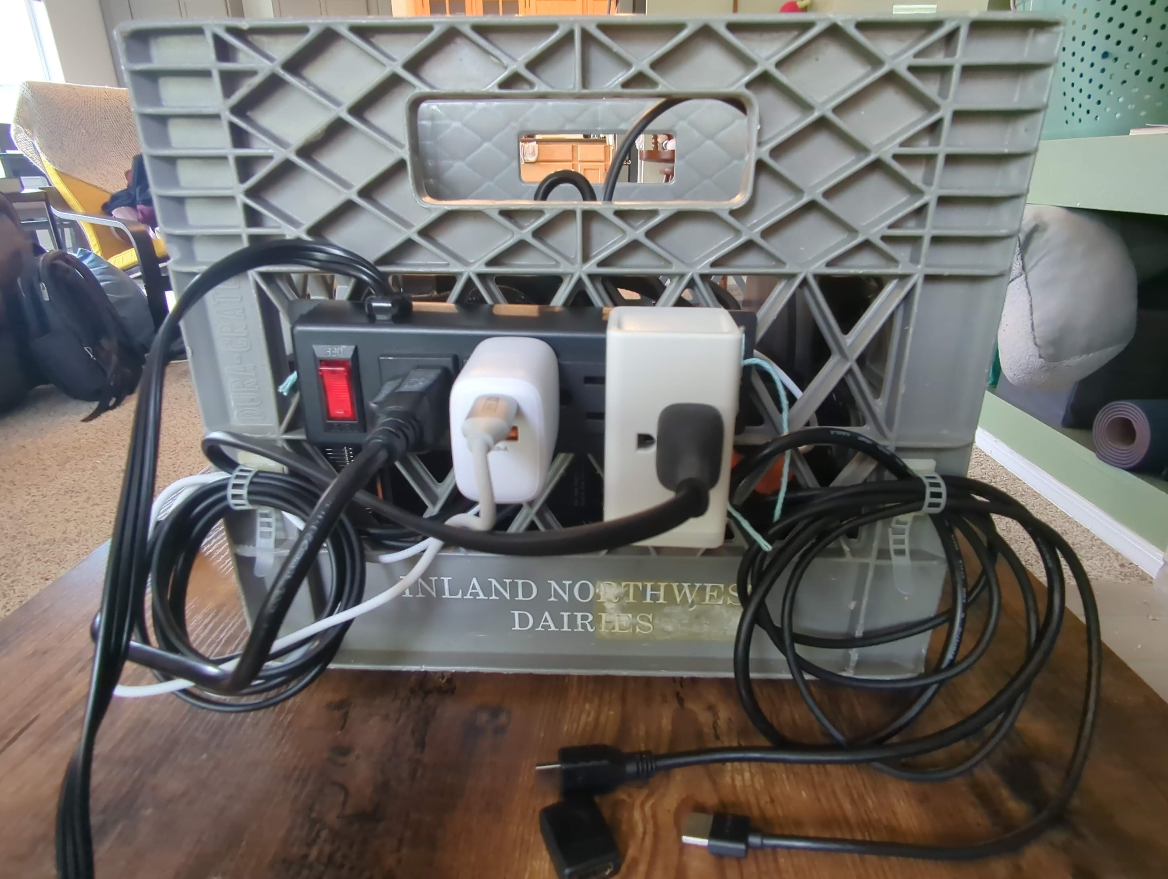 The power strip mounted to the back of the milk crate